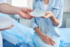 Woman holding breast implants during consultation in Cincinnati, OH